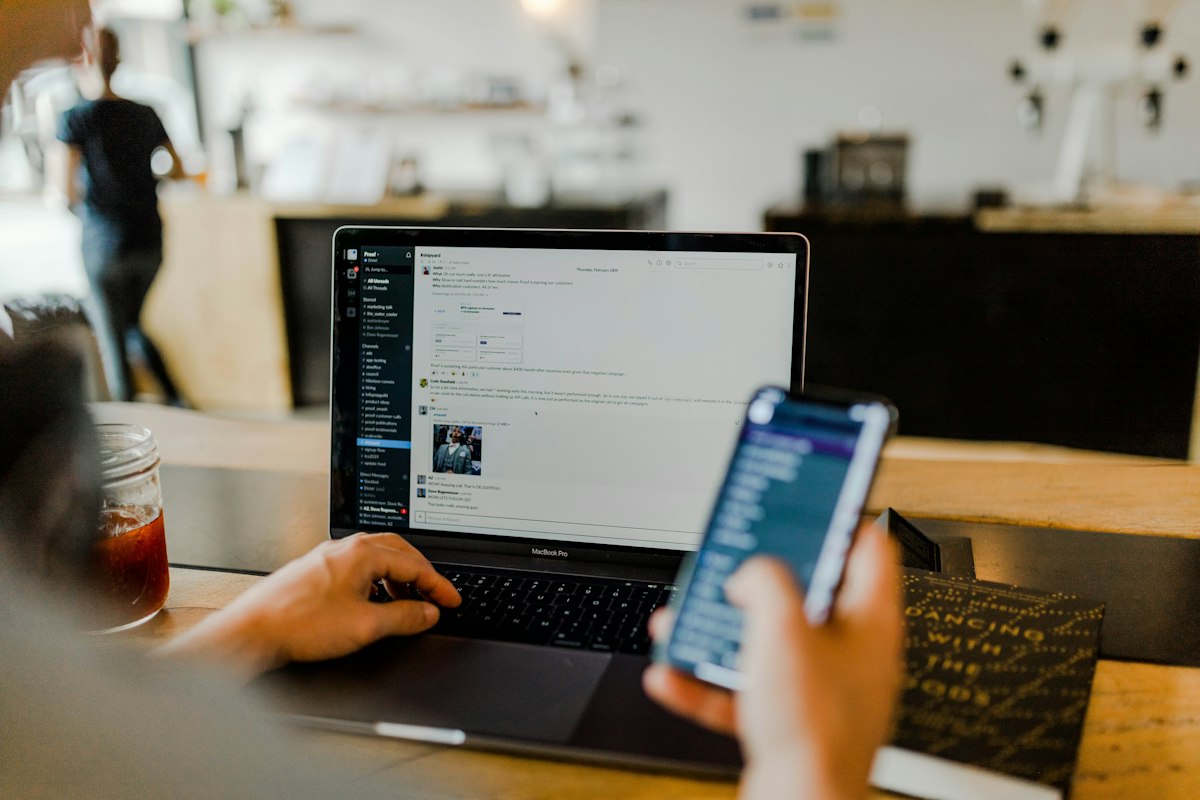 Writing a professional email on a laptop with tone suggestions