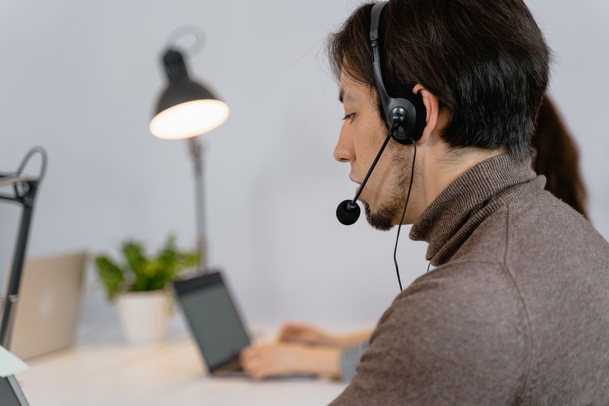 Focused support agent with a headset providing professional customer service