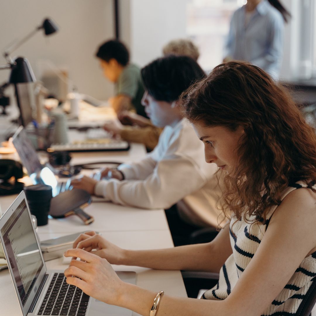 Team of professionals collaborating around a desk in a bright office