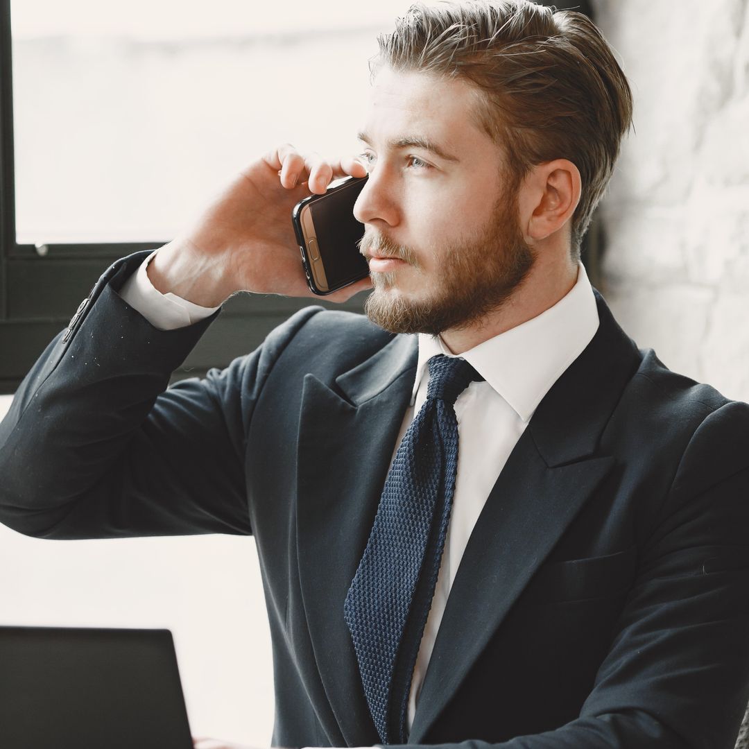 Man in a suit on a phone call in an office