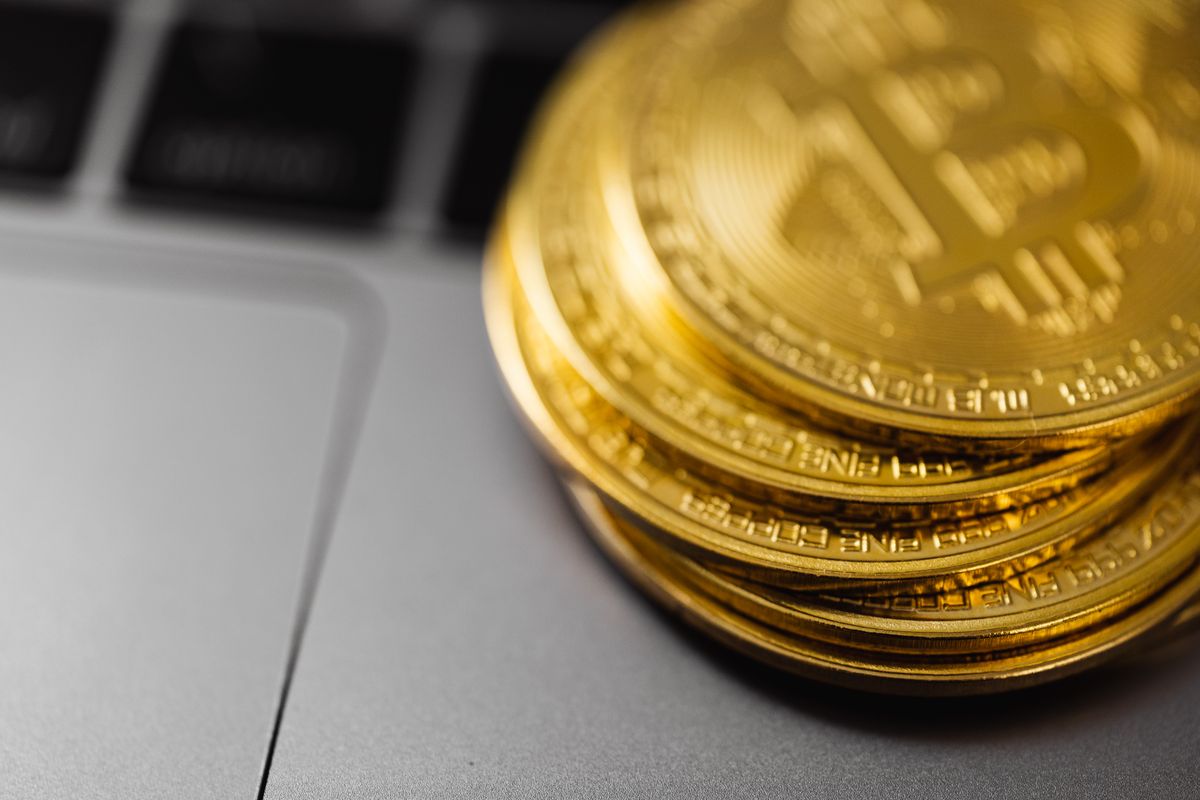 Bitcoin coins placed on a laptop computer