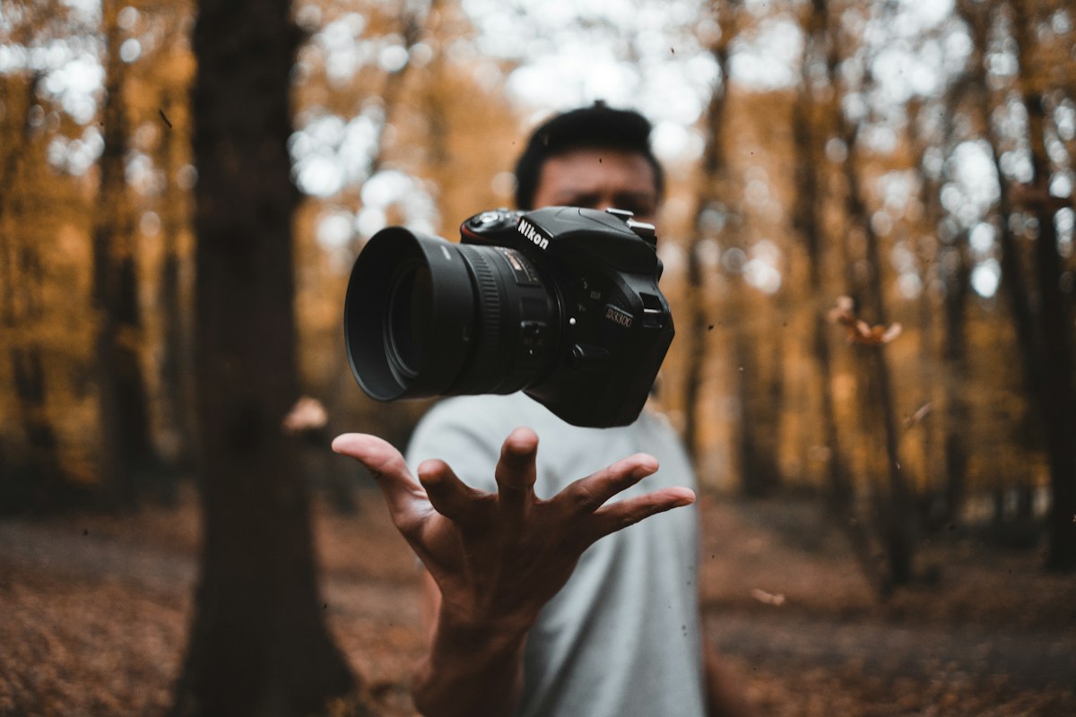 A photographer uploading smartphone photos to a stock platform dashboard