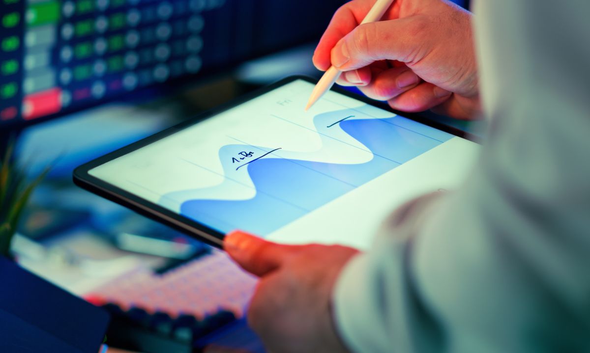 Marketer analyzing a data analytics dashboard on screens