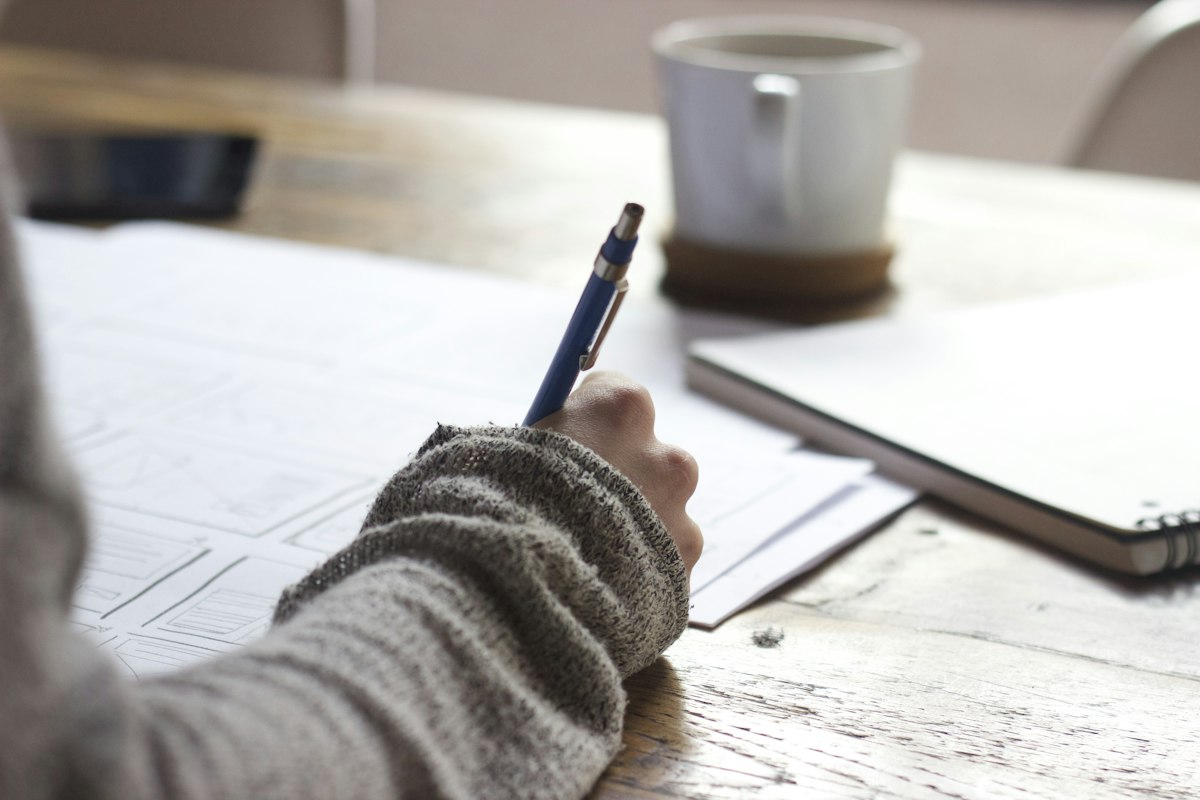 Hand writing career plans and goals in a notebook