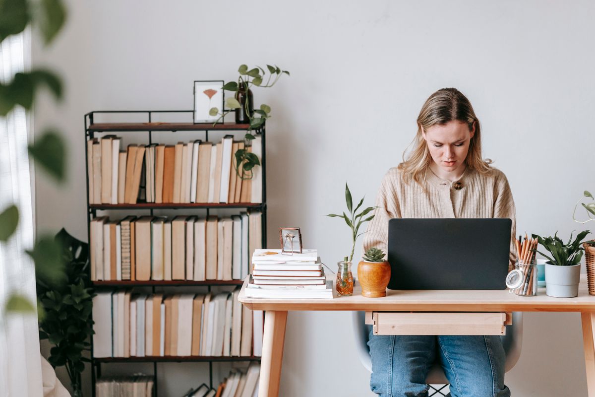Freelancer working on a laptop at a home desk