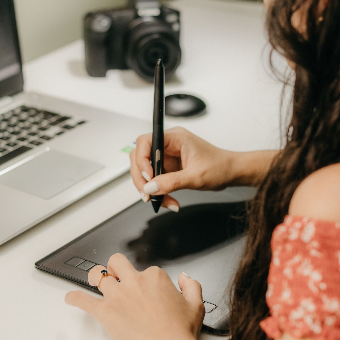 A designer creating a t-shirt design on a digital tablet