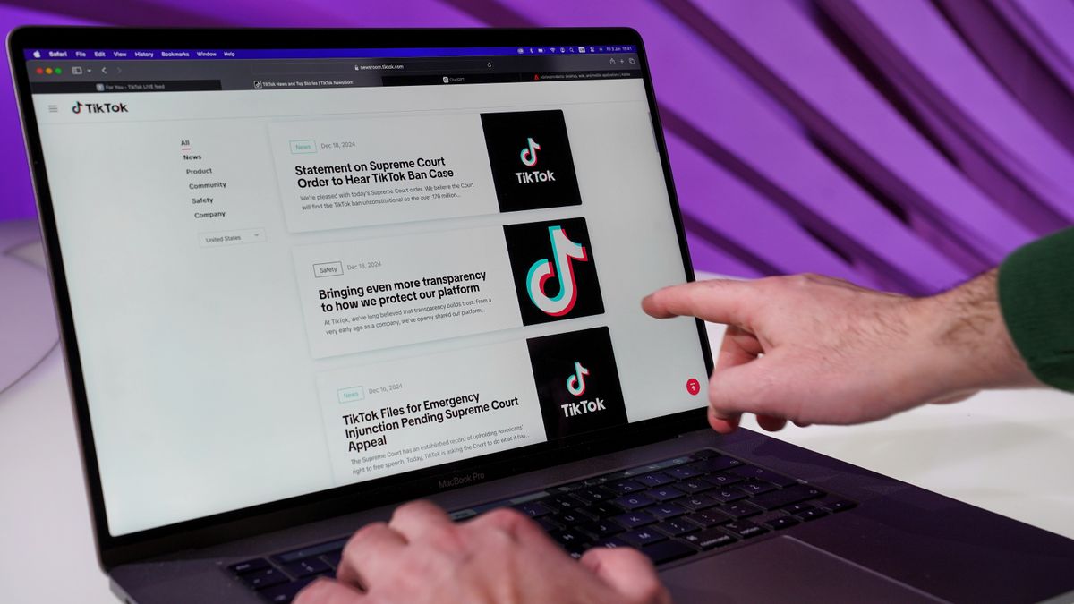 Close-up of a laptop screen showing a social content feed with comments