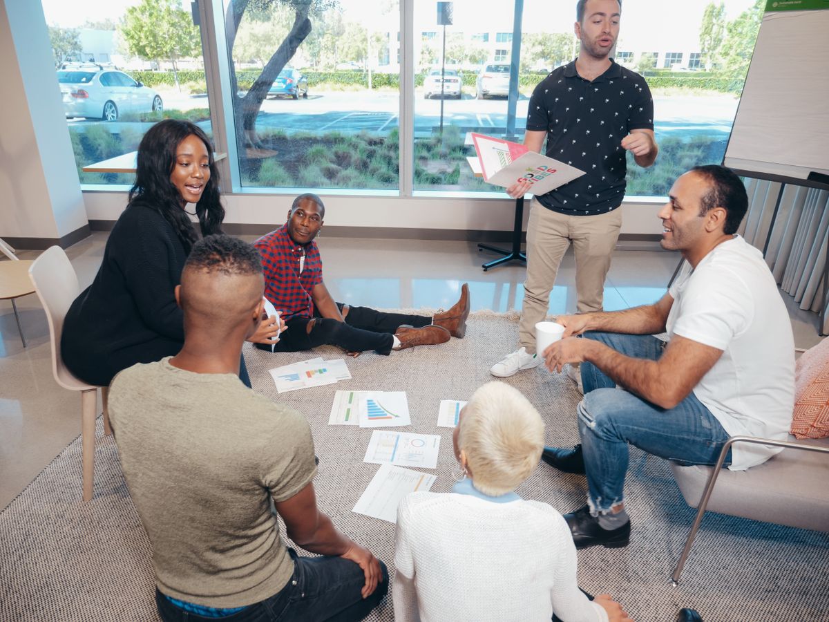Diverse group of people in a community-style discussion together