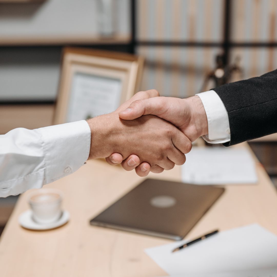 Two people shaking hands in an office