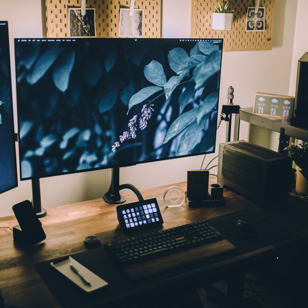 Wooden desk with desk lamps and an open laptop in a home office