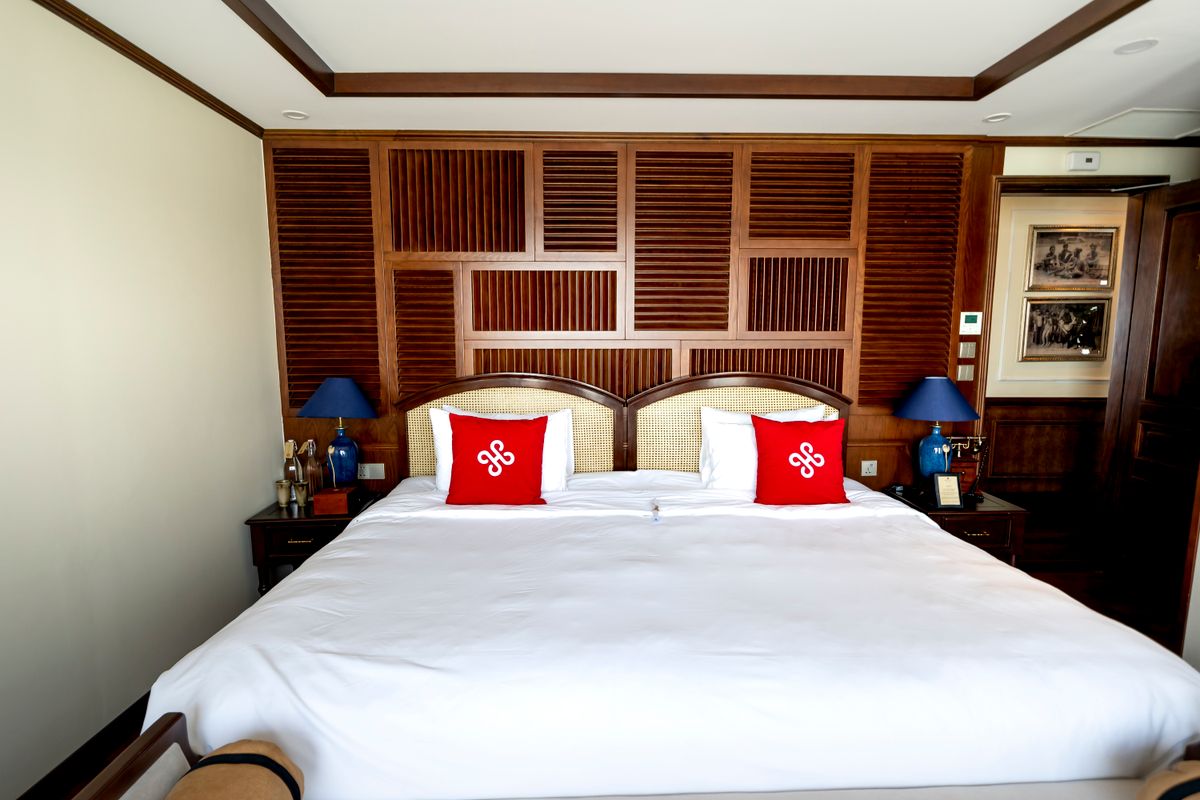 Elegant short-term rental bedroom with wood accents and a king bed