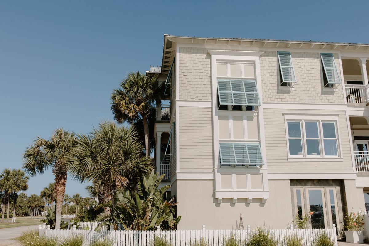 Stylish beach house with palm trees, a classic vacation rental property