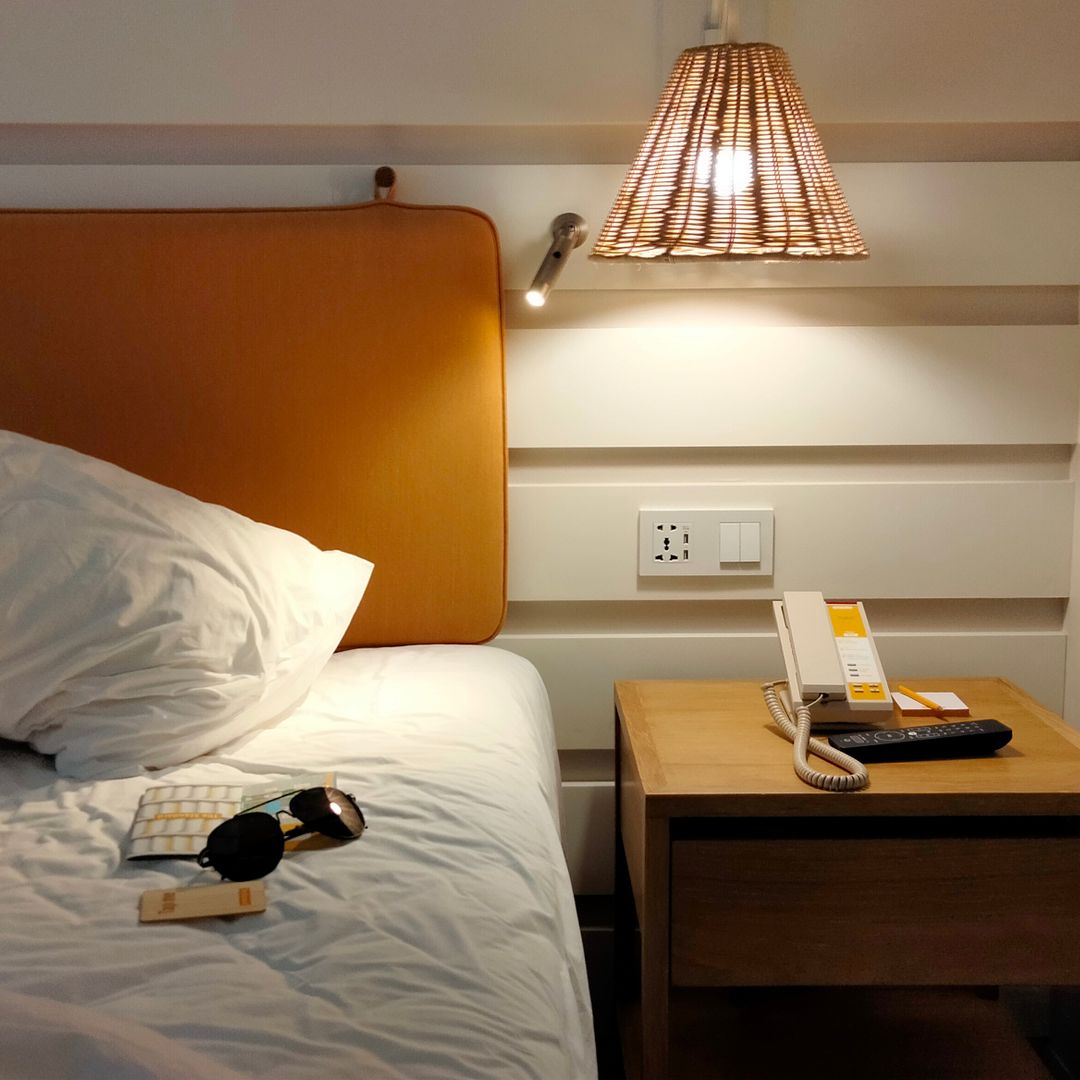 Cozy short-term rental bedroom with lamp-lit nightstand