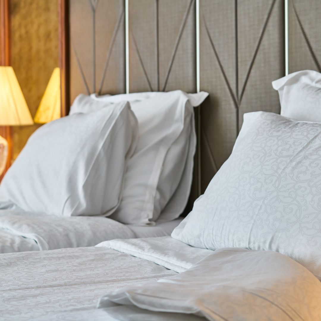 Hotel-style short-term rental room with warm ambient lighting