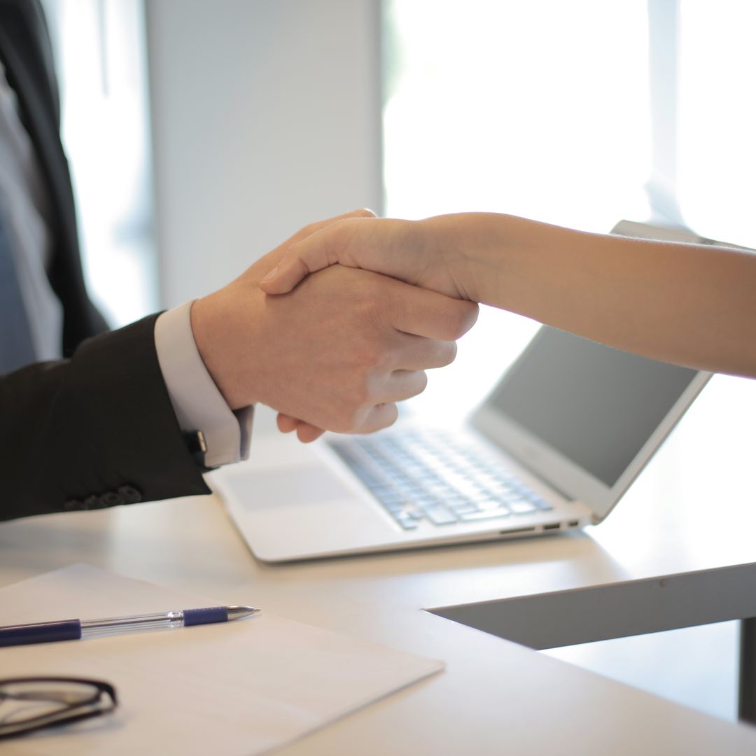 Two business people shaking hands to close a deal