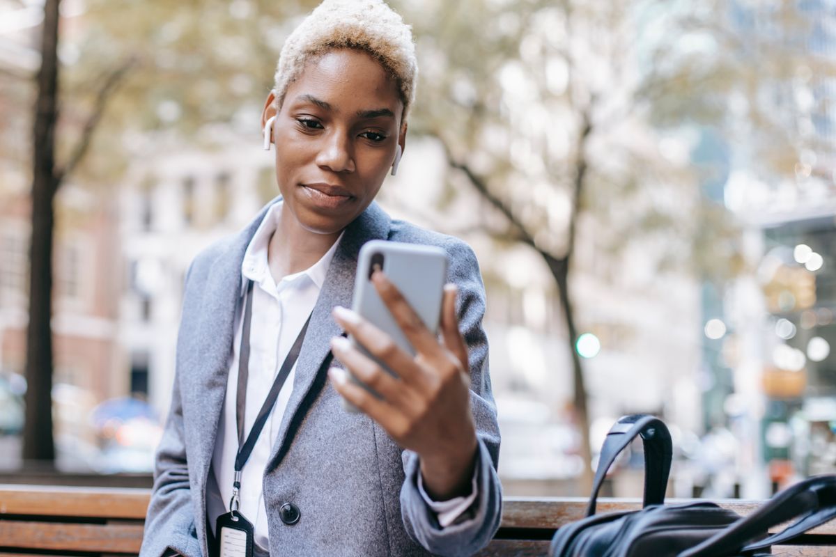 A person reading a newsletter on a smartphone