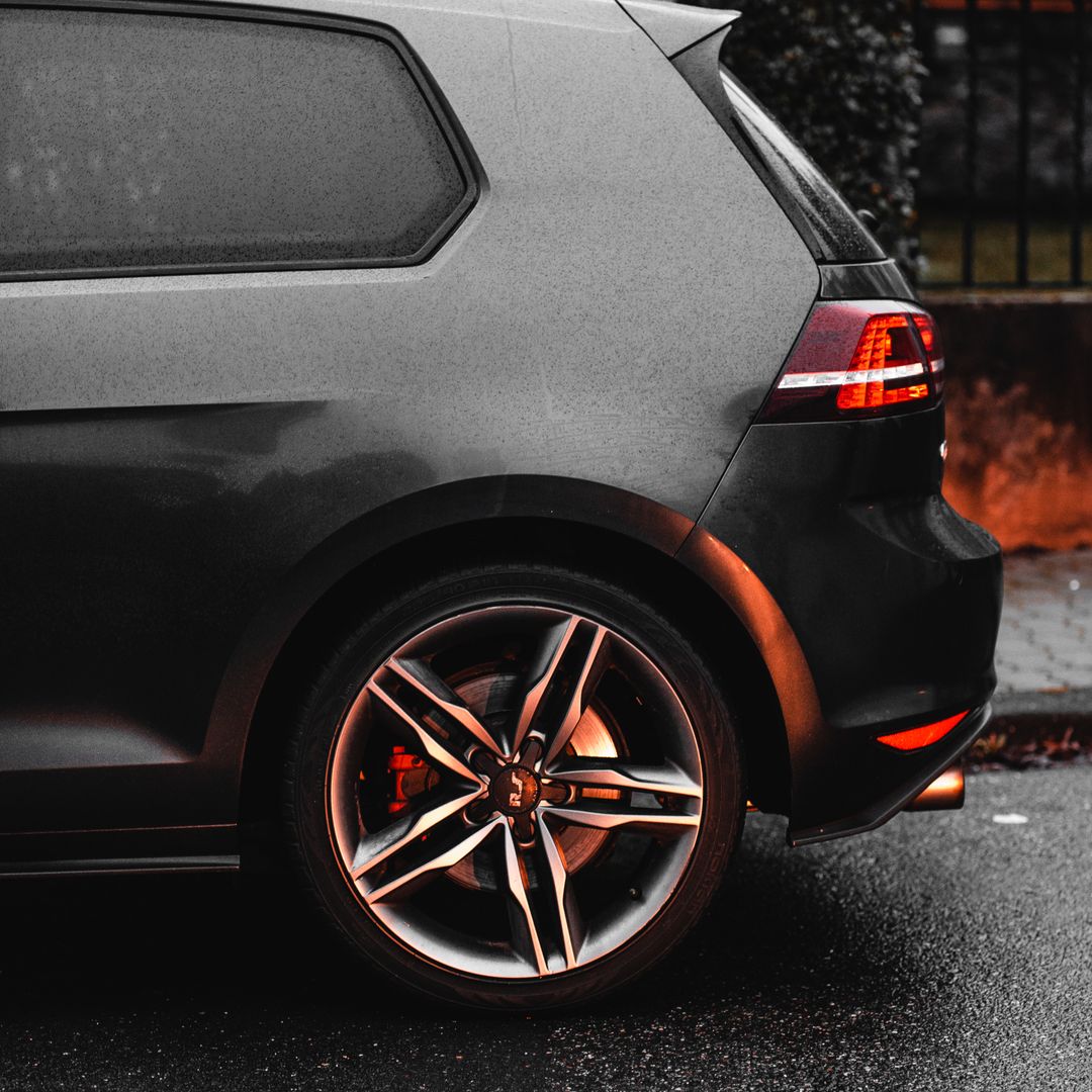 A modern car parked on a wet street, ready for rental listing photos