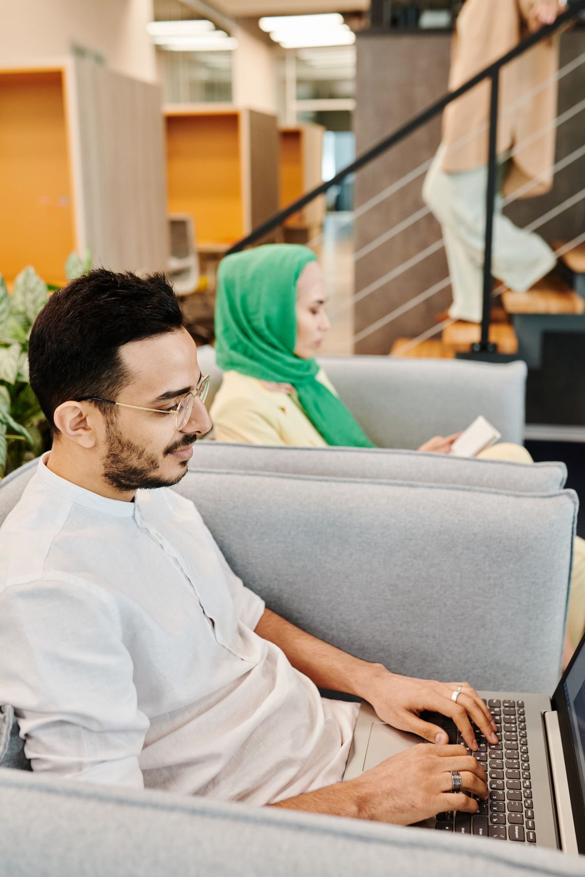 Man working on a laptop in a bright modern office space